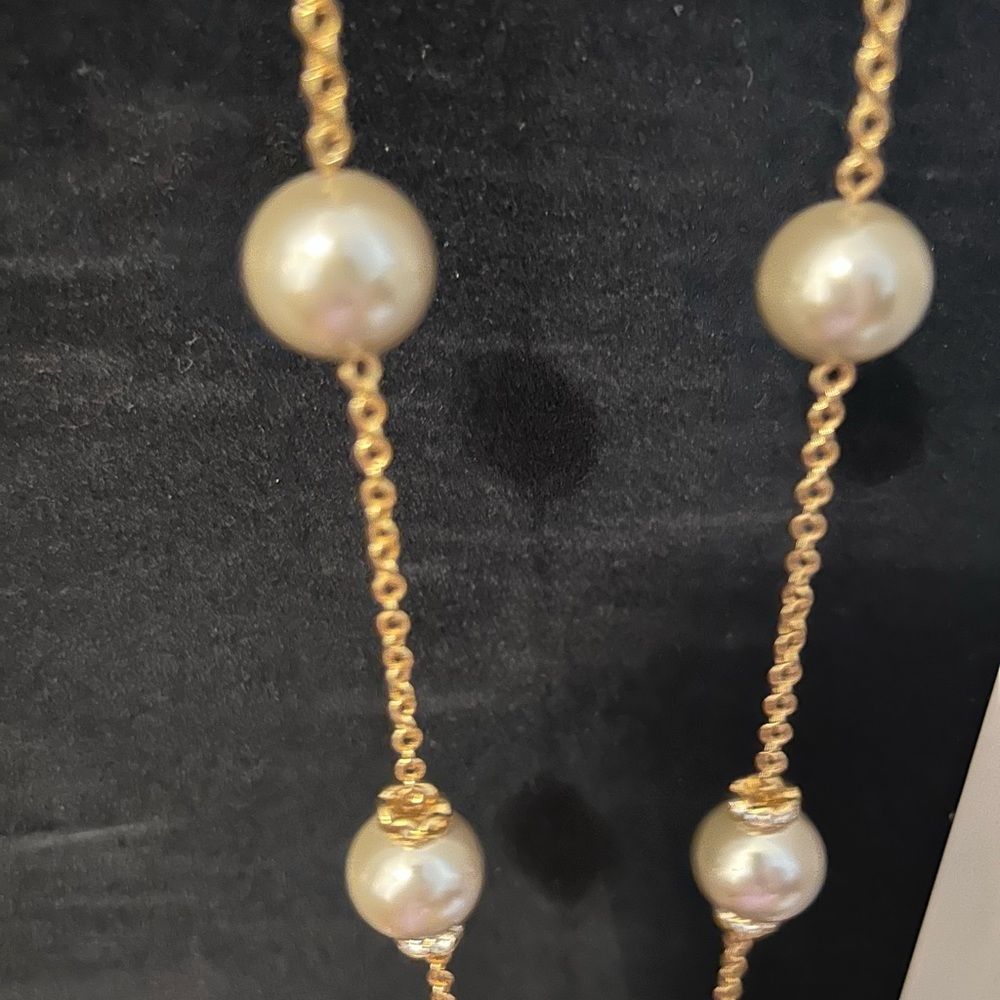 Costume Jewelry - strand of beads . The beads look like Pearls on a gold chain.
